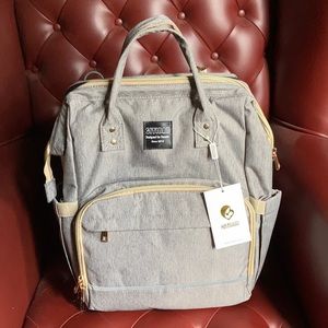 Backpack diaper bag with pop out changing station